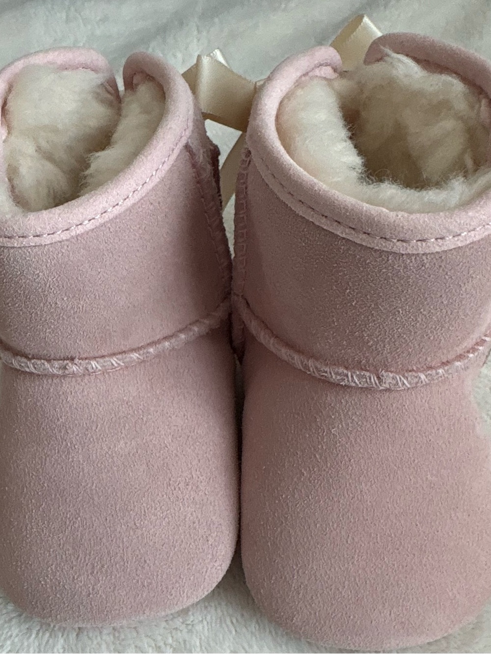 Authentic baby UGG Jessie Bow II bootties in Baby Pink.